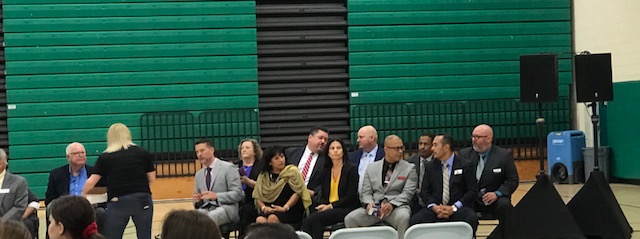 People in suits are sitting at the meeting