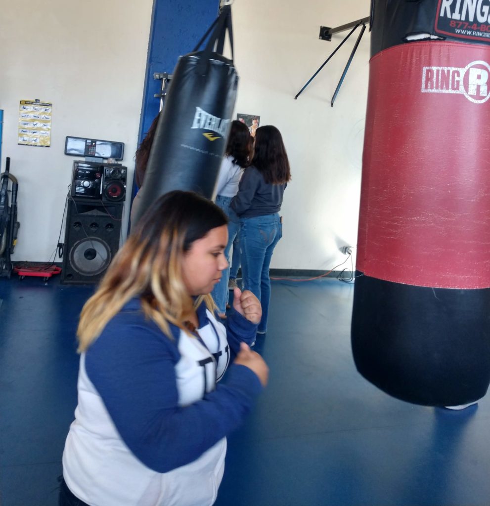 Girl preparing to hit a punching bag